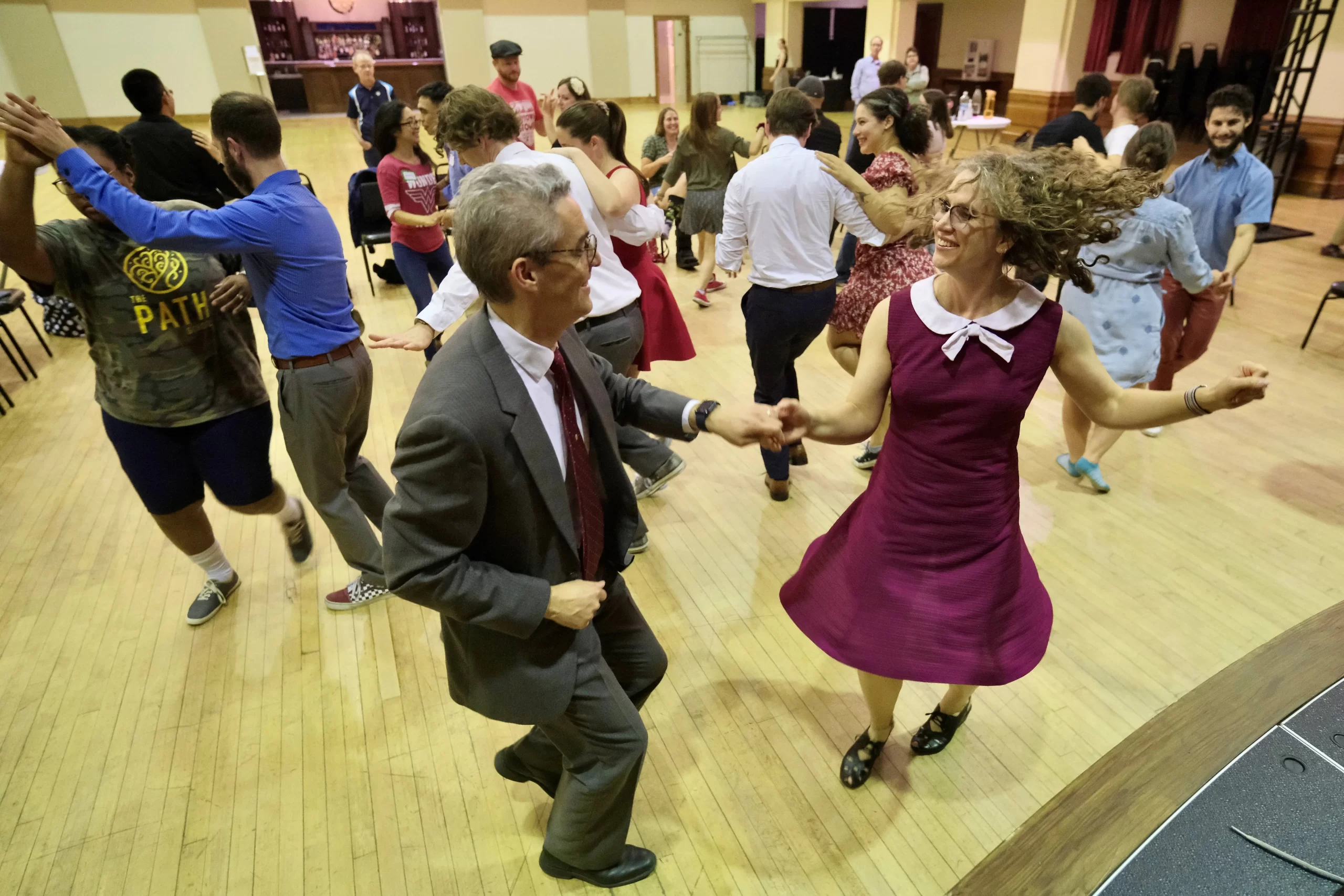 People swing dance at McGowan Hall during the weekly social dance.